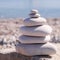 Symbol Scales is made of stones of various shapes. Balance of stones. Balancing stones on the shore. Tourism, travel.