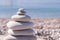 Symbol Scales is made of stones of various shapes. Balance of stones. Balancing stones on the shore. Tourism, travel.