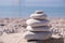 Symbol Scales is made of stones of various shapes. Balance of stones. Balancing stones on the shore. Tourism, travel.