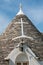 Symbol in the Trullo conical rooftop in Alberobello, Apulia, Italy