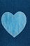 Symbolic heart made of jeans lying on dark jeans