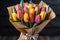 Symbolic tulip bouquet expresses tender care as woman receives vibrant spring flowers