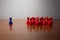 Symbolism wooden red and blue figures for business exclusion racism mobbing hate religions