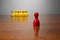 Symbolism wooden red and yellow figures for business exclusion racism mobbing hate religions