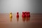 Symbolism wooden red and yellow figures for business exclusion racism mobbing hate religions