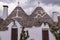 Symbols on the conical roofs of Alberobello in Italy