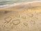 Symbols of the hearts drawing on the sand on the beach of Tel Baruch . Tel Aviv Promenade. Israel