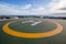 Symbols for helicopter parking on the roof of an office building. Empty square front of city skyline.