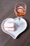 Symbols of Reims on heart shaped board - glass of rose brut champagne and rose biscuits