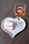 Symbols of Reims on heart shaped board - glass of rose brut champagne and rose biscuits