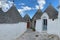 The symbols on the roofs of trulli along the street at Alberobello, Apulia, Italy