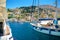 SYMI ISLAND, GREECE, JUNE 25, 2013: View on beautiful classic sea ocean yachts, Greek sea port, houses on island hills, tourists,