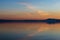 Symmetrcal, beautiful view of Trasimeno lake Umbria, Italy at sunset, with orange and blue tones in the sky