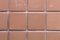 Symmetric Squares of an Orange Exterior Tile Wall of a Building