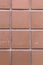 Symmetric Squares of an Orange Exterior Tile Wall of a Building