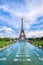 Symmetrical front panoramic view of Eiffel tower on the bright sunny afternoon taken from fountains of Trocadero