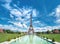 Symmetrical front panoramic view of Eiffel tower on the bright sunny afternoon taken from fountains of Trocadero