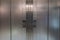 Symmetrical metal elevator doors with buttons to go up or down