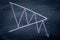 Symmetrical Triangle stock exchange graph pattern write on chalkboard , stock price pattern action analysis in finance concept