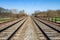 Symmetry railway in spring countryside under blue sky