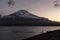 Symmetry snowcapped volcano mountain Fuji against Yamanakako famous tourist lake