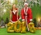 Sympathetic young people in the form of a snowgirl and Santa Claus with figures for the new year 2018 and new year trees in new