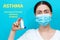 Symptoms of allergy asthma. Portrait of a woman in a medical mask, shows an inhaler. Blue background with text