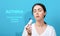 Symptoms of asthma. Portrait of sad young woman holding inhaler. Blue background. Text