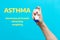 Symptoms of asthma. A woman`s hand holds an inhaler with medicine, pressing the pump. Blue background with text