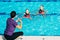 Synchronized Swimmers with trainer