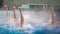 Synchronized swimming. Slender legs girls athletes stick out of the water in open pool in winter. Young girls learn