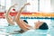 Synchronized, swimming and woman in competition performance, event or dance together in pool, water or sport. Athlete