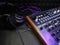 Synthesizer with headphones on black background with purple patch cable