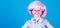 Synthetic hair. Cool little child with pink hair wig. Adorable small girl with fancy hair style wearing headphones