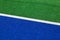 Synthetic hockey sideline closeup blue and green