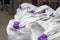 Synthetic white bags with purple handles for building bulk materials