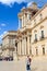 Syracuse, Sicily, Italy - Apr 10th 2019: Tourists on Piazza Duomo Square in Ortygia Island. Dominant of the historical center