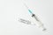Syringe and ampoule with label Covid-19 on white background. Ampoules with vaccine for coronavirus