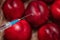 Syringe with chemical injection close-up. Blurred peaches in the background. The concept of GMO foods, vegetables and fruits