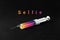 A syringe on a dark background and the word selphi. The concept of mania, Internet addiction