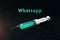 A syringe on a dark background and the word whatsapp. The concept of Internet addiction, messenger mania