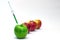 Syringe injection into a red apple. Genetic modified foods