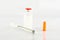 Syringe and insulin vial on white background