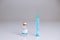 Syringe leaning on a vaccine bottle with COVID-19 sign on white  background. Global pandemic and healthcare concept.