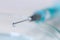 Syringe with medical fluid drop background