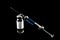 Syringe and medicaments on a black backgroun