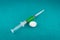 Syringe with medicine on green background