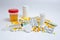 Syringe, medicine pills, capsules, vials, urine test on grey concrete background
