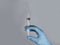 Syringe with needle in doctors hands in glove