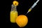 Syringe in orange with juice
